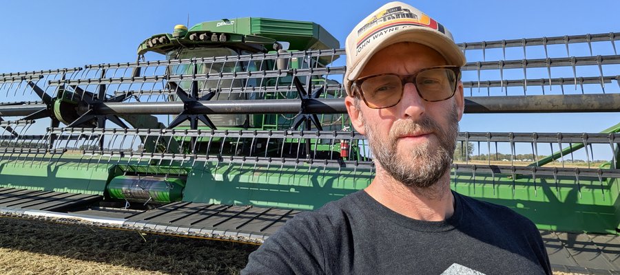 Me standing in front of the combine