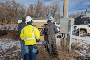Men in work attire looking at things