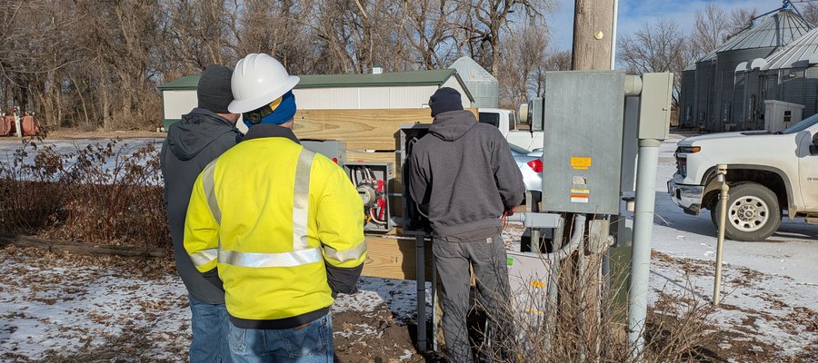 Men in work attire looking at things
